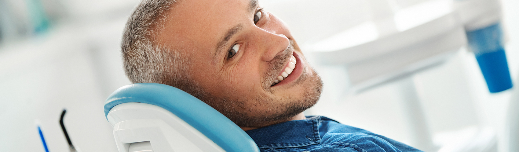 guy in dental chair smiling
